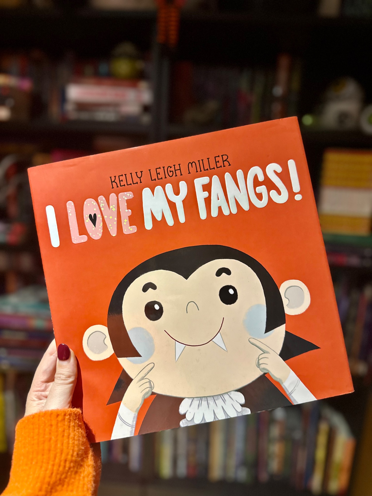 October Jones holding I Love My Fangs!